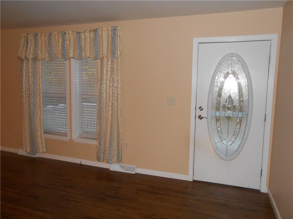 7224 Country Club Road Butler, PA 16001 - Photo 10 of 43 a view of a livingroom with wooden floor and a window