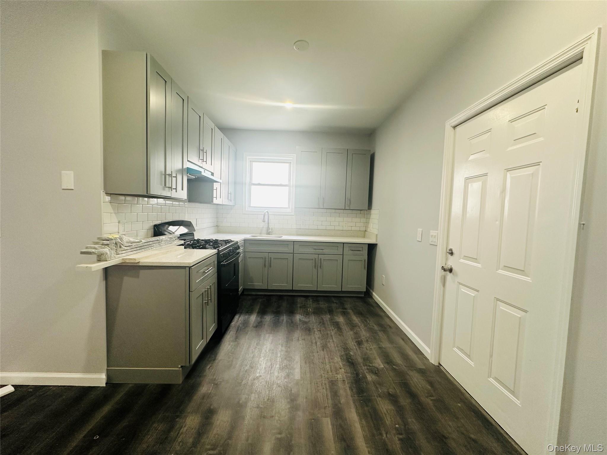 8 Morgan Avenue, Unit 1 Poughkeepsie, NY 12601 - Photo 2 of 11 a kitchen with a sink a counter top space and cabinets