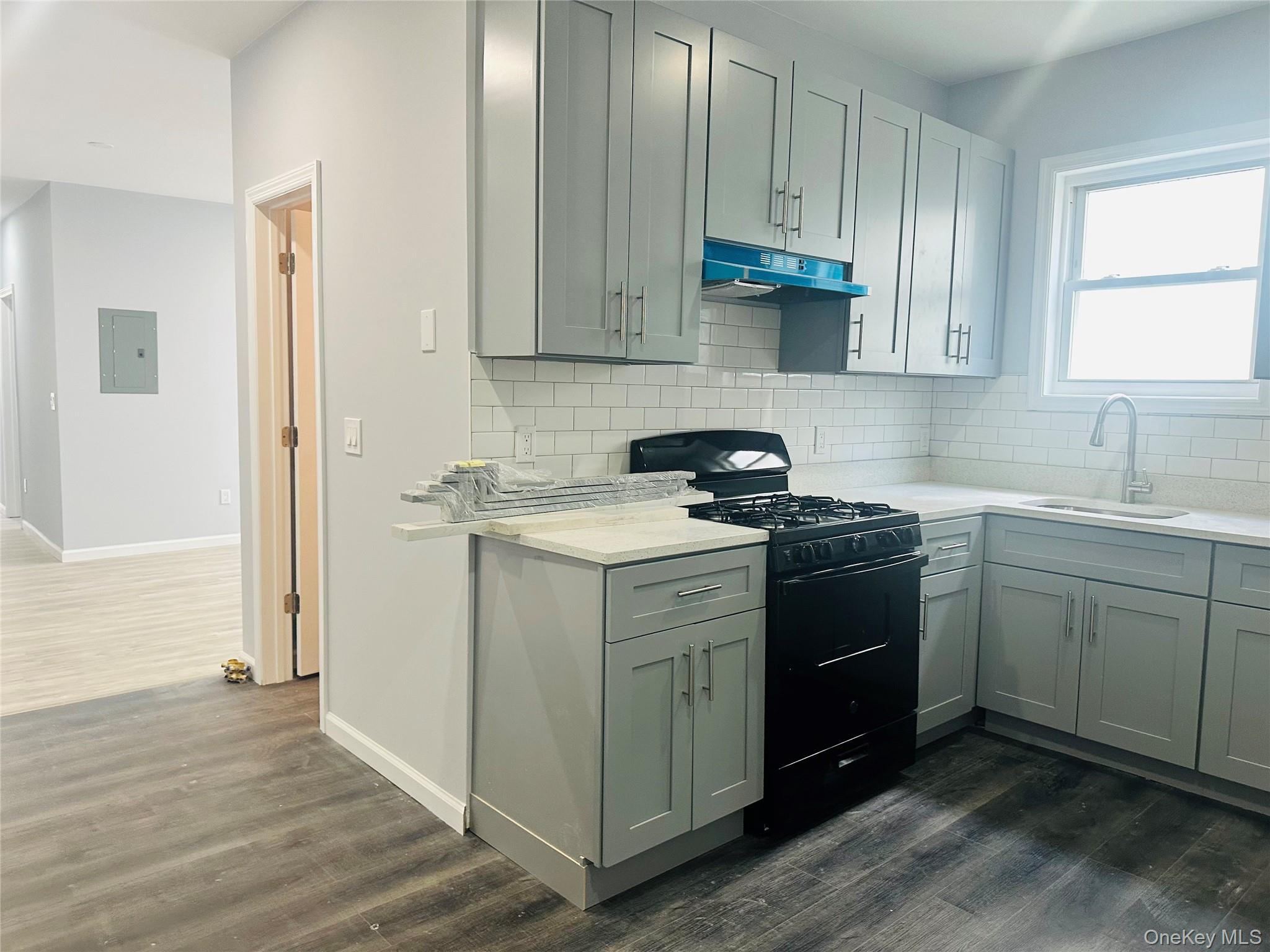 8 Morgan Avenue, Unit 1 Poughkeepsie, NY 12601 - Photo 3 of 11 a kitchen with stainless steel appliances granite countertop a sink stove and cabinets