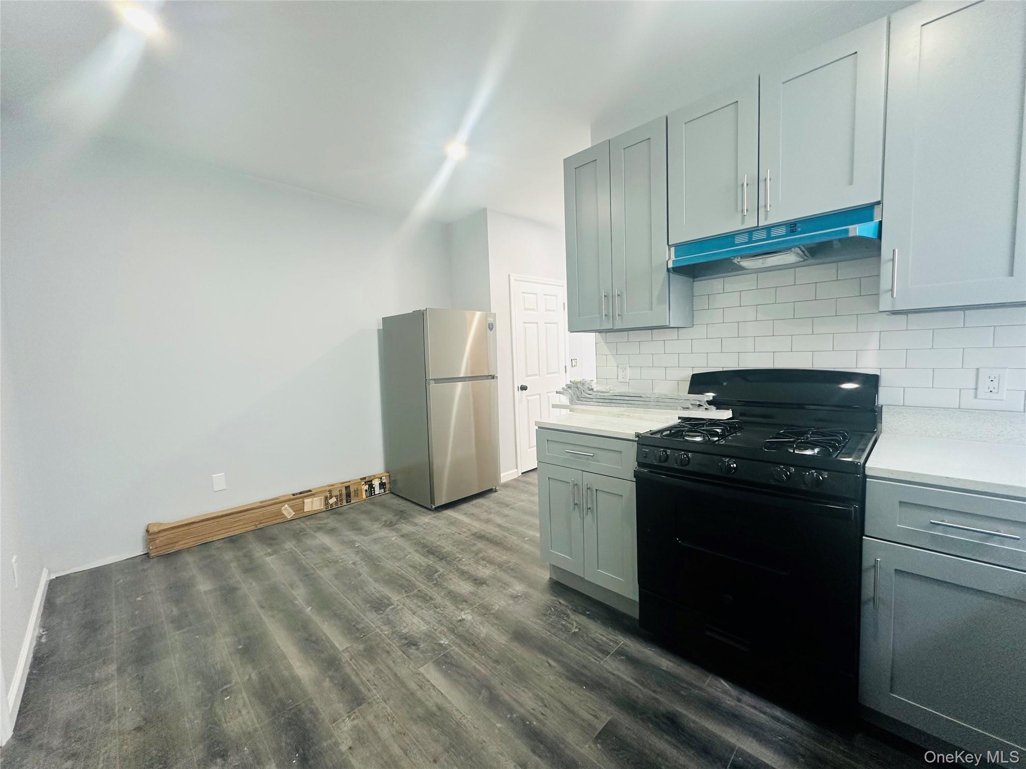 8 Morgan Avenue, Unit 1 Poughkeepsie, NY 12601 - Photo 5 of 11 a kitchen with granite countertop a stove and a refrigerator