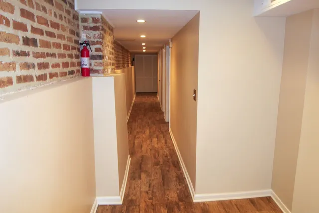 a view of a hallway with wooden floor