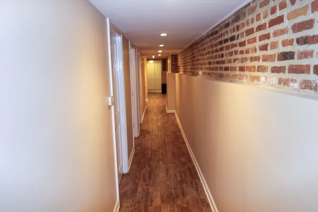 a view of a hallway with wooden floor