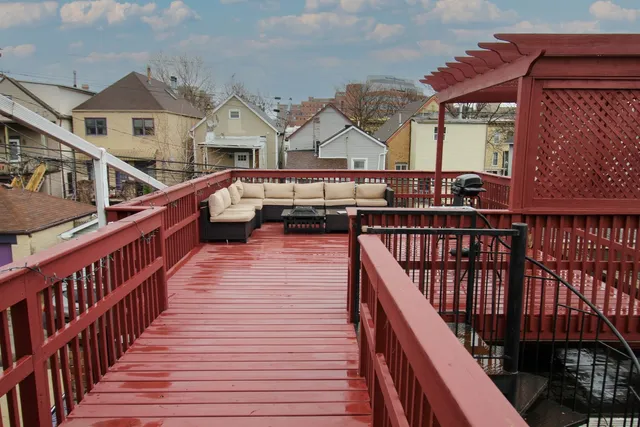 a view of balcony with wooden floor and fence