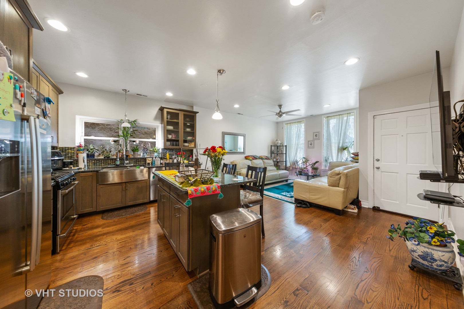815 South Bell Avenue Chicago, IL 60612 - Photo 3 of 39 a living room with furniture kitchen view and a wooden floor