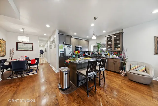 a living room with furniture and kitchen view