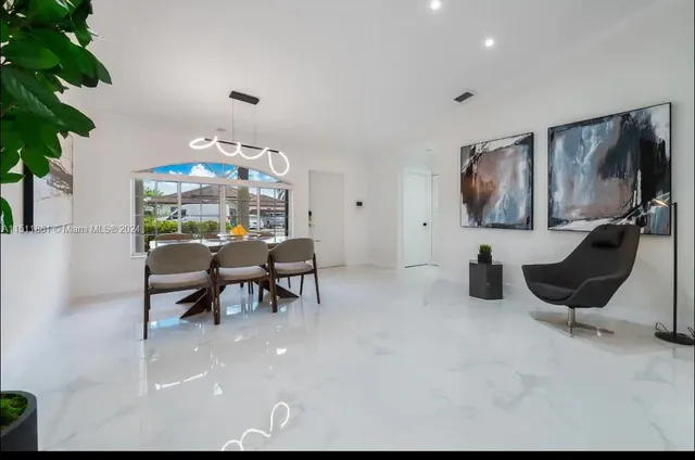 a dining room with furniture and chandelier
