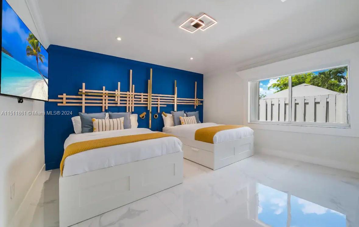 14236 Southwest 164th Terrace Miami, FL 33177 - Photo 13 of 29 a bedroom with furniture and a chandelier