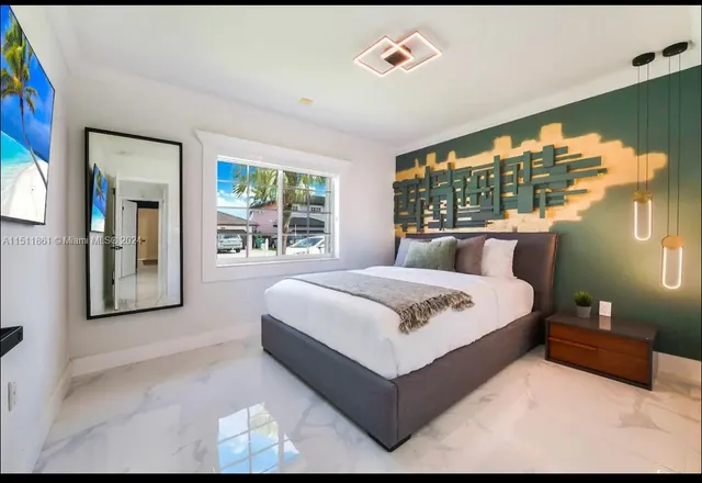 a bedroom with a large bed and a large window