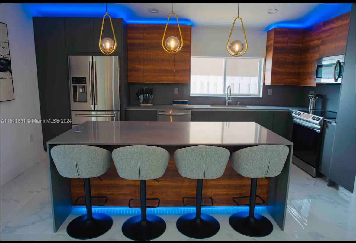 14236 Southwest 164th Terrace Miami, FL 33177 - Photo 16 of 29 a kitchen with dining table and chairs