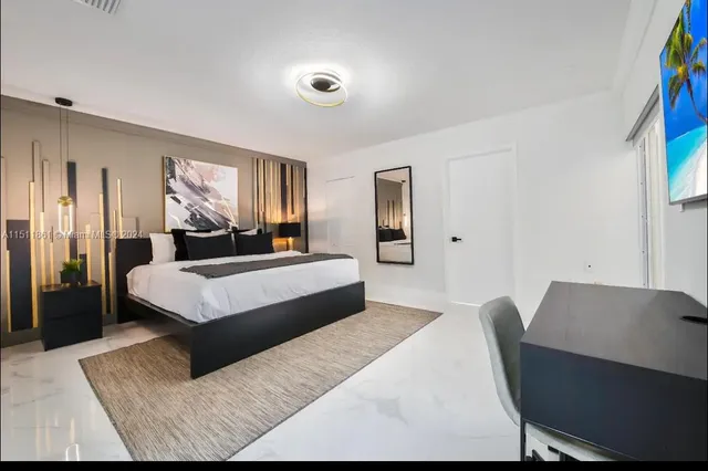 a bedroom with a bed couch and a window