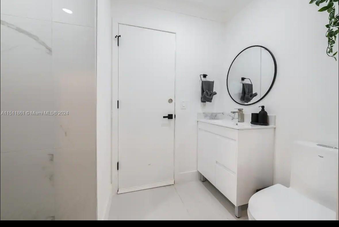 14236 Southwest 164th Terrace Miami, FL 33177 - Photo 23 of 29 a bathroom with a sink a mirror and a toilet