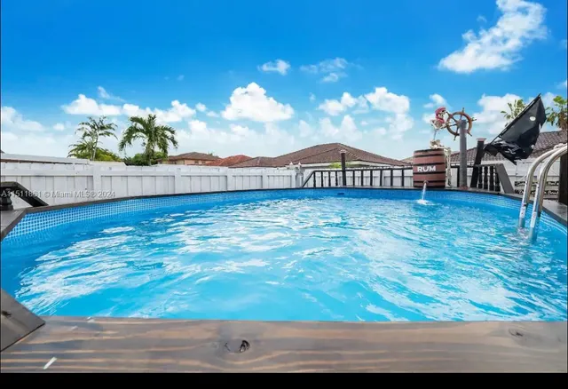 a living room with a table and potted plant