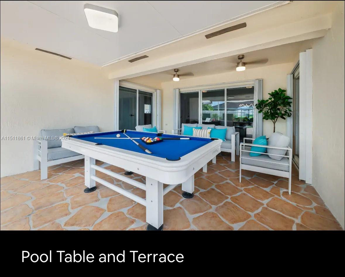 14236 Southwest 164th Terrace Miami, FL 33177 - Photo 25 of 29 a living room with a table and potted plant