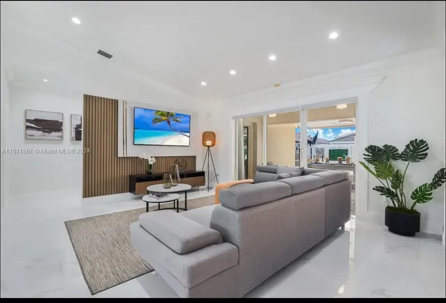 a living room with furniture potted plant and a window