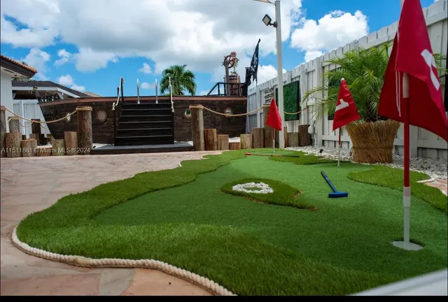 a view of a house with a big yard and sitting area