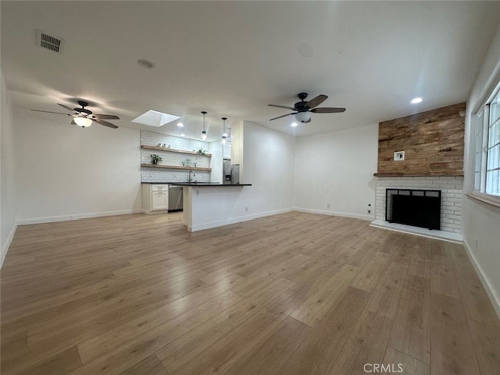 8772 Sumner Place Cypress, CA 90630 - Photo 3 of 8 a view of a livingroom with a fireplace a sink and dishwasher kitchen view