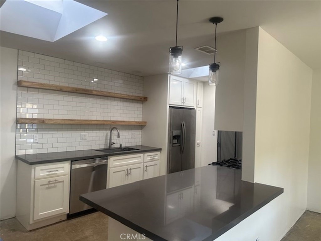 8772 Sumner Place Cypress, CA 90630 - Photo 4 of 8 a kitchen with stainless steel appliances granite countertop a sink a refrigerator and a stove