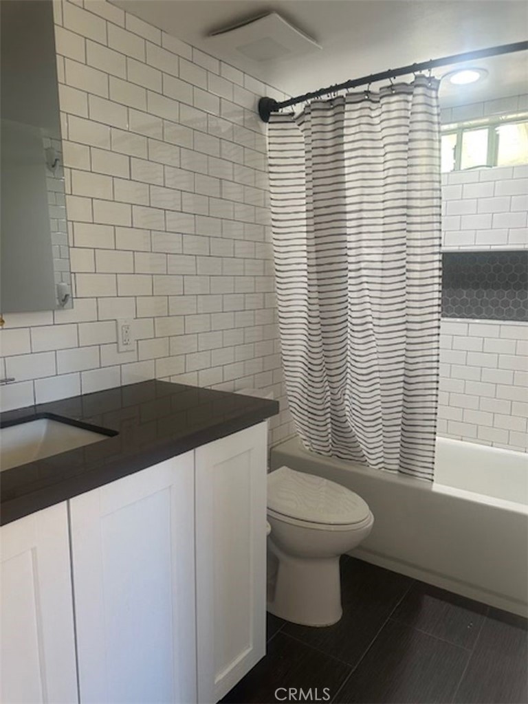 8772 Sumner Place Cypress, CA 90630 - Photo 7 of 8 a bathroom with a sink a toilet and shower