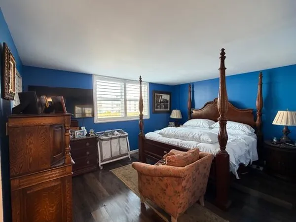a bedroom with furniture and wooden floor
