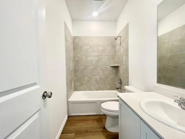 a bathroom with a toilet a sink and bathtub