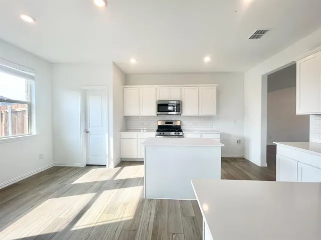a kitchen with sink and refrigerator