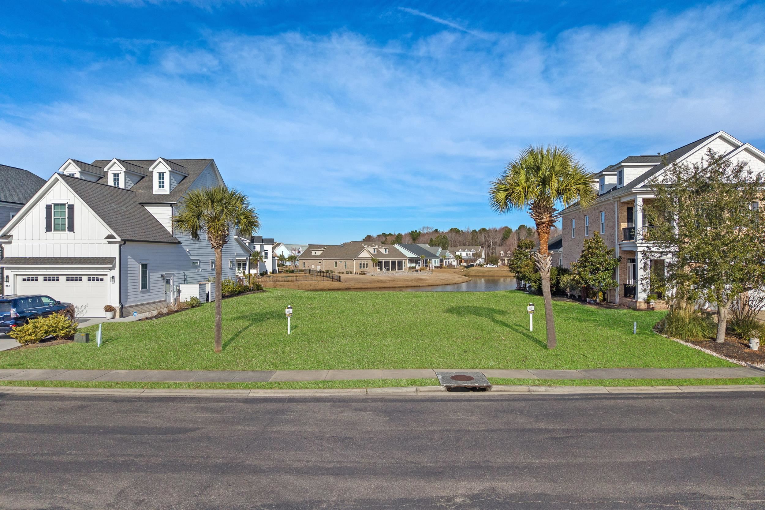 Surrounding community featuring a residential view, a yard, and a water view