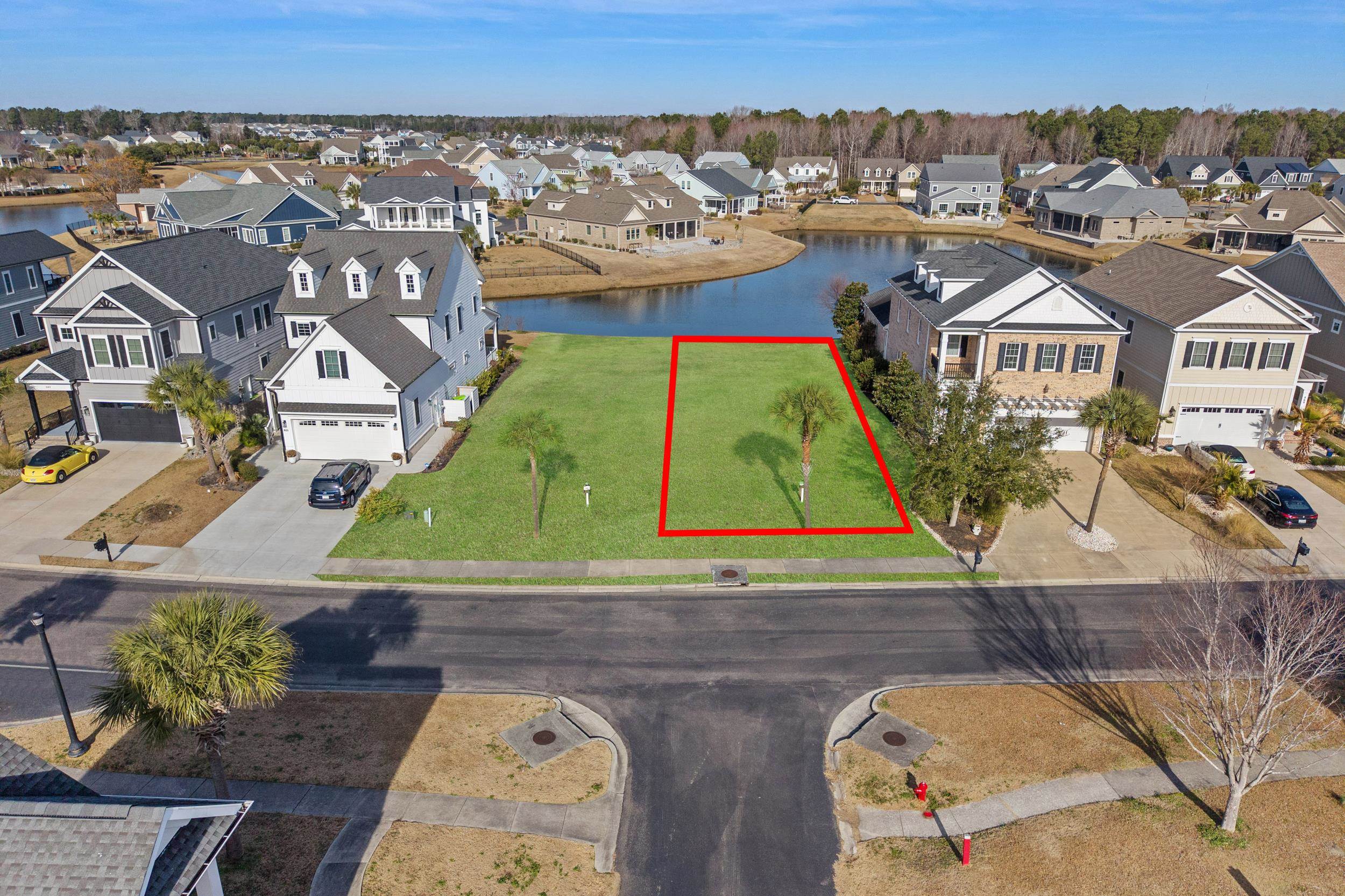 861 Crystal Water Way Myrtle Beach, SC 29579 - Photo 2 of 20 Aerial view of residential area with property boundaries highlighted and a large body of water