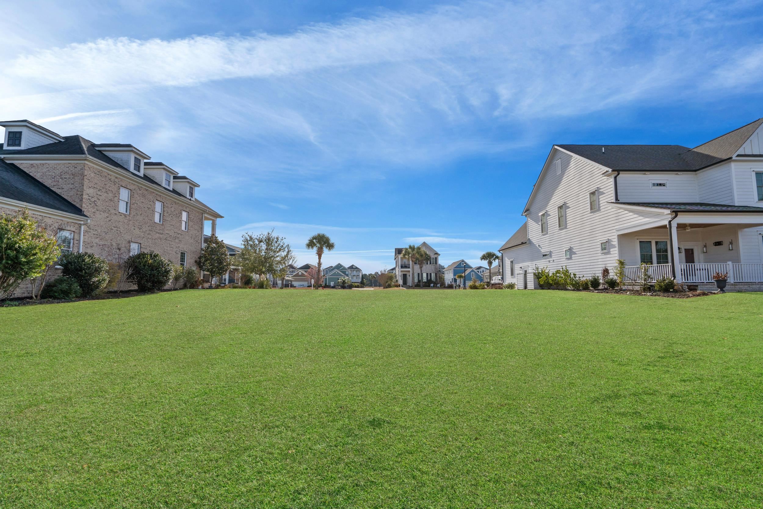 861 Crystal Water Way Myrtle Beach, SC 29579 - Photo 7 of 20 View of grassy yard with a residential view and covered porch