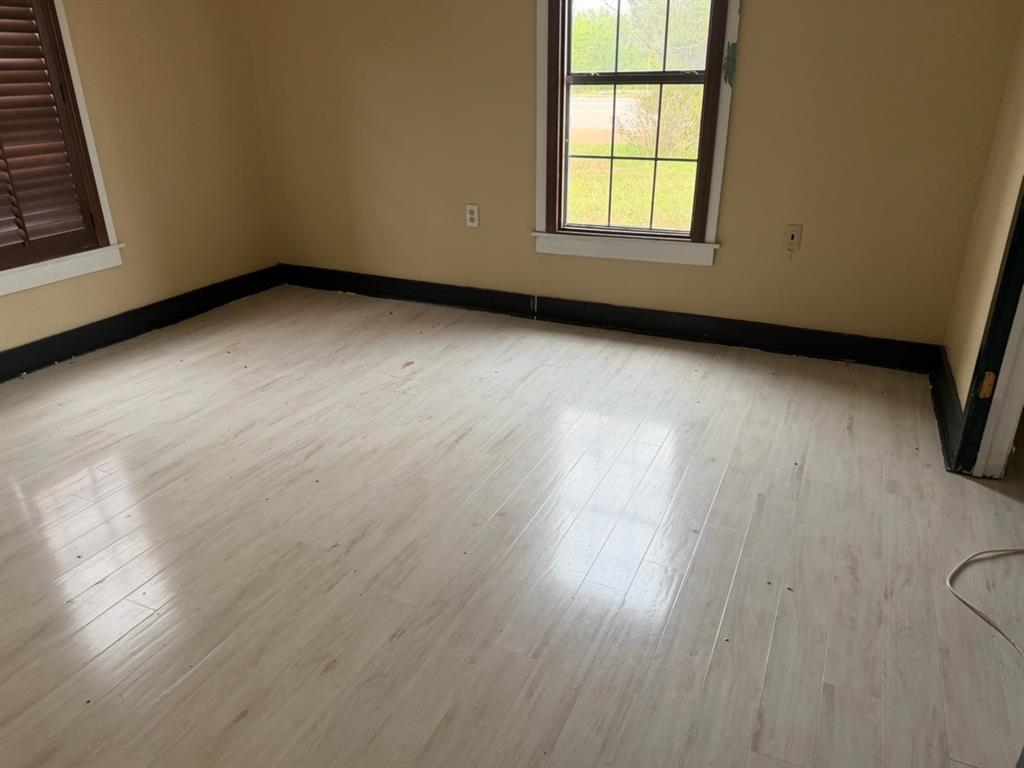 4050 Old Anson Road Abilene, TX 79601 - Photo 7 of 40 an empty room with wooden floor and windows