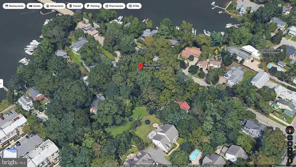 an aerial view of a house with a yard lake and outdoor seating
