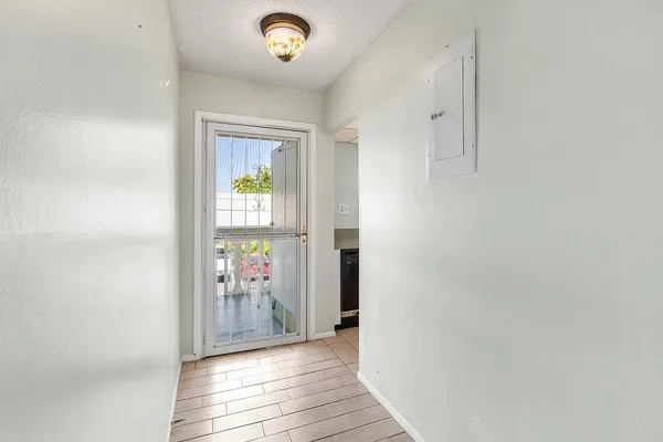 a view of hallway with wooden floor