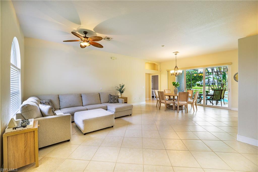 5235 Malvern Court Naples, FL 34112 - Photo 5 of 28 a living room with furniture and a large window