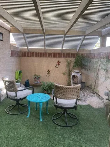a view of a chairs and table in backyard