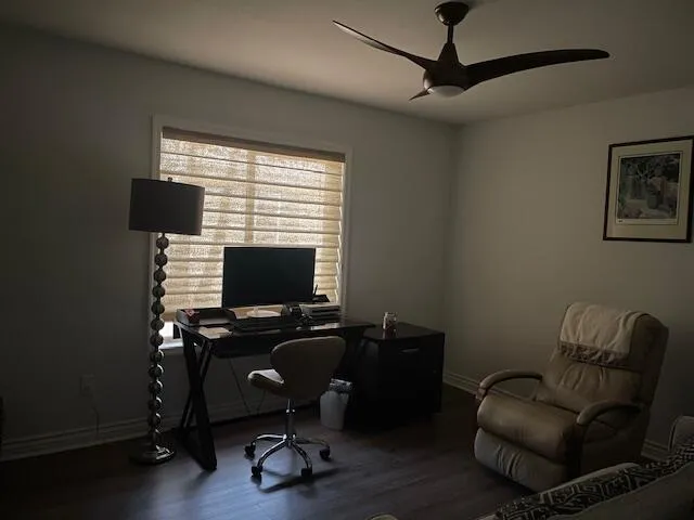 a view of a workspace with furniture and a window