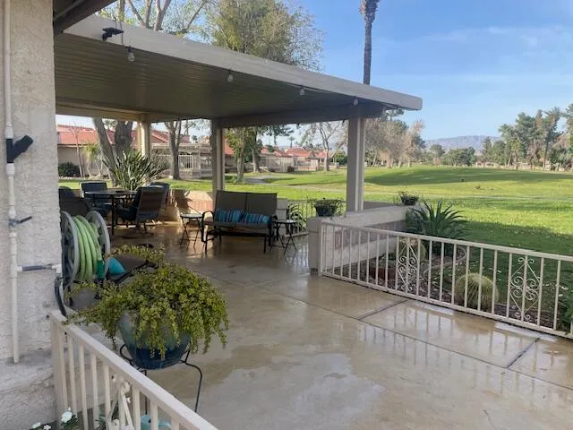 a view of a patio with chairs and a table