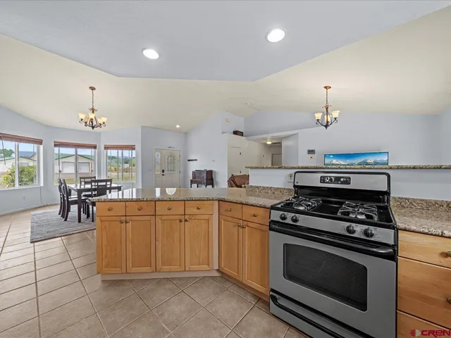 a kitchen with stainless steel appliances a stove a sink cabinets and a counter top space