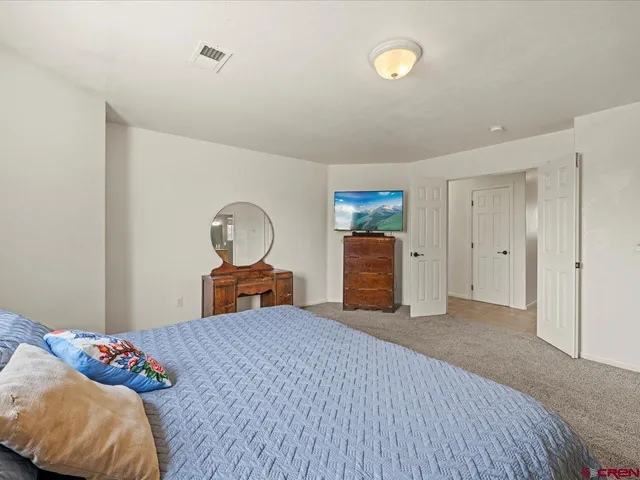 a bedroom with a bed and a dresser