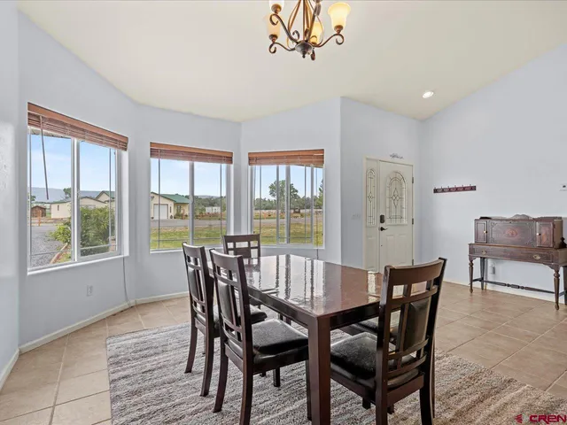 a view of a dining room with furniture window and outside view