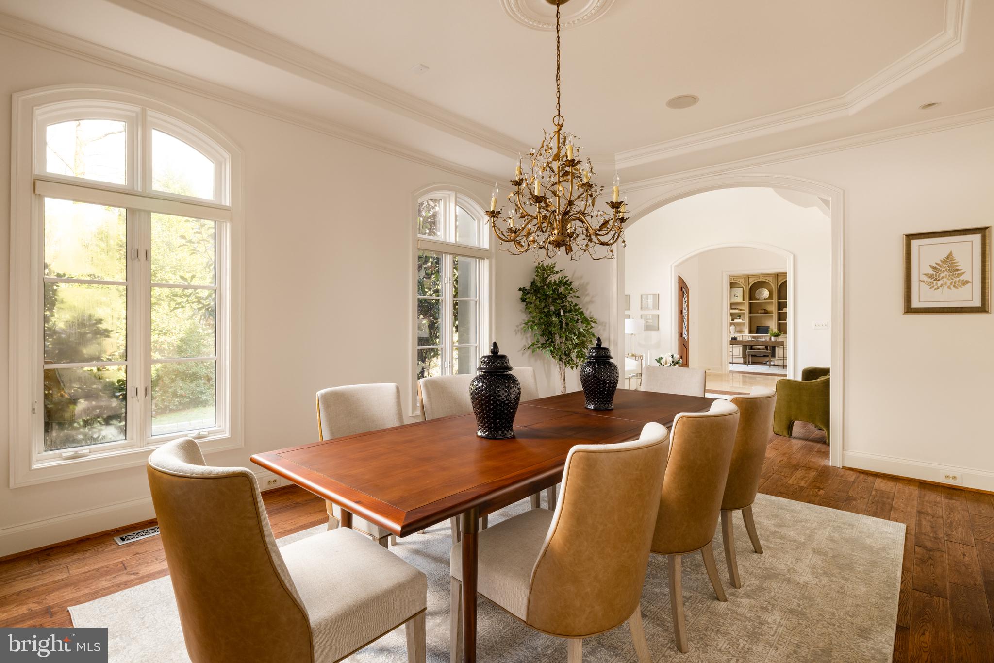 9250 Persimmon Tree Road Potomac, MD 20854 - Photo 11 of 47 a dining room with furniture a chandelier and wooden floor