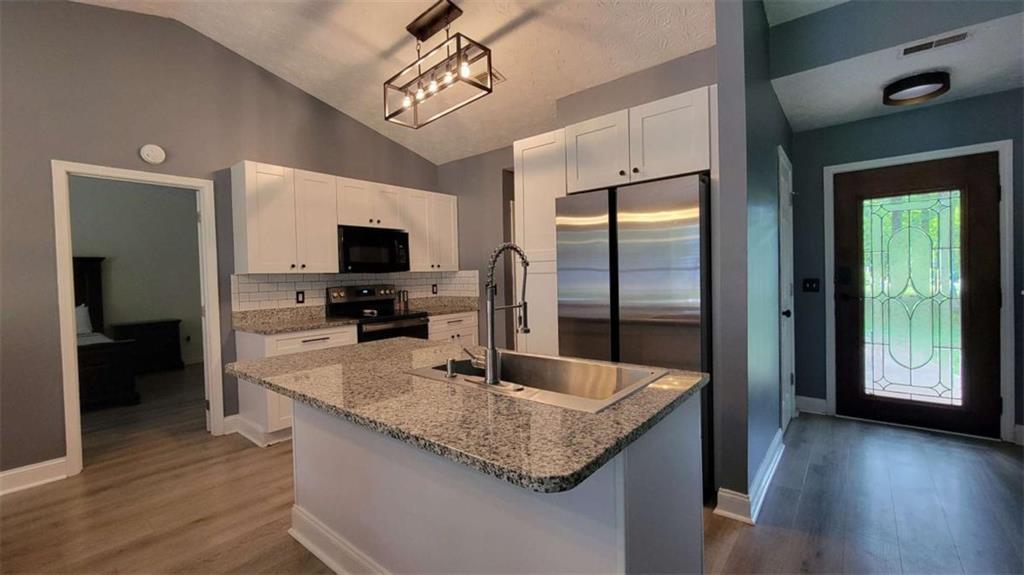 2140 Summerset Drive Monroe, GA 30656 - Photo 9 of 43 a kitchen with stainless steel appliances granite countertop a sink refrigerator and microwave