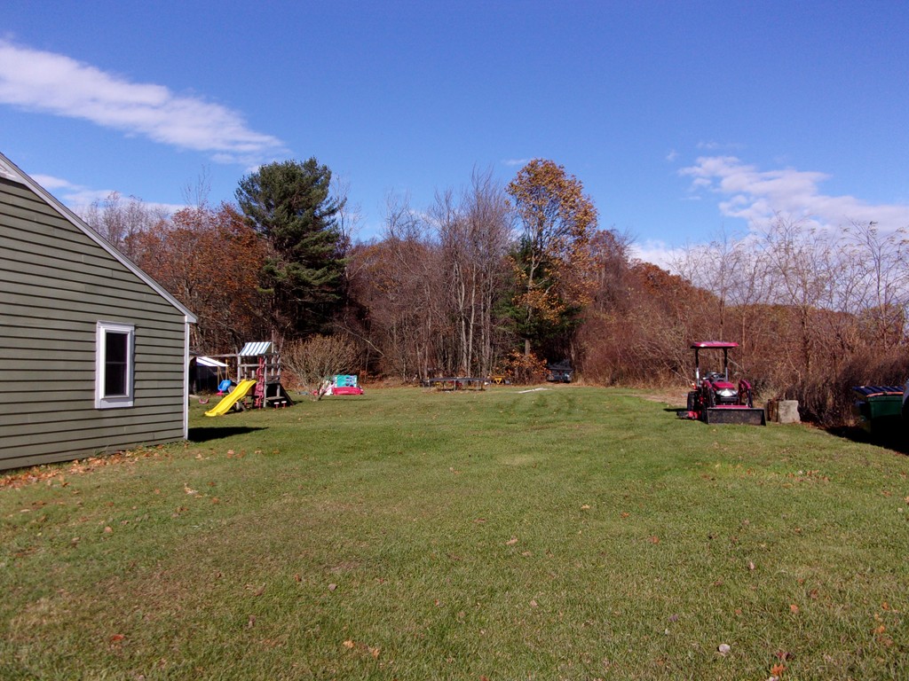 145 Main Road Westhampton, MA 01027 - Photo 3 of 30 a view of a house with a backyard and a tree