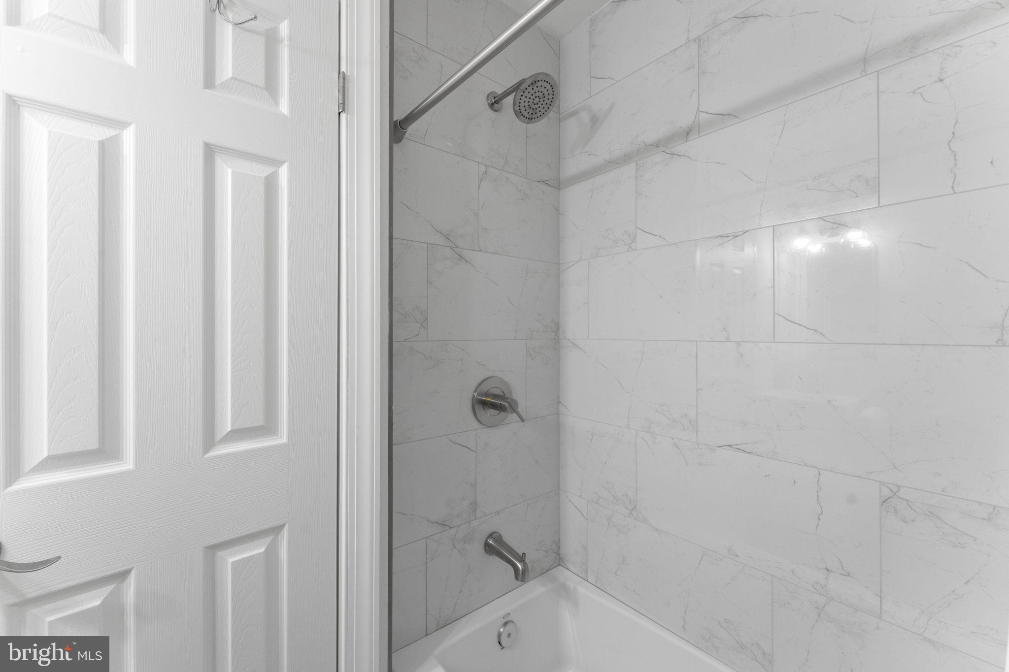 6406 Gildar Street Alexandria, VA 22310 - Photo 15 of 32 Beautifully finished shower in primary en-suite.