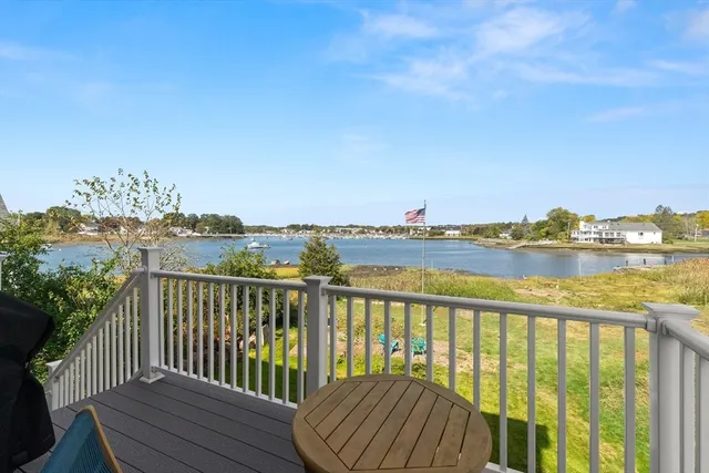 a view of a balcony with wooden floor and city view