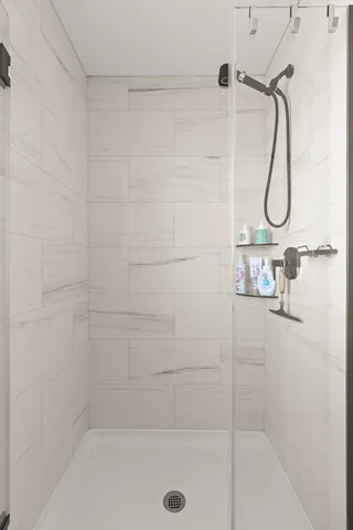 a bathroom with a bath tub with a shower