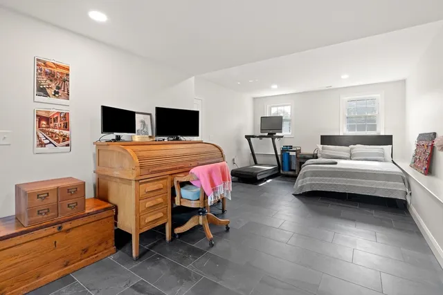 a bedroom with furniture and a flat screen tv