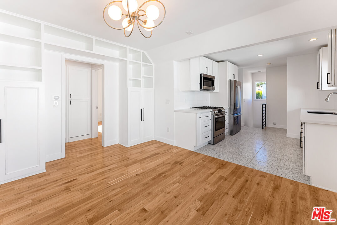 1253 South Rimpau Boulevard Los Angeles, CA 90019 - Photo 22 of 71 a view of a kitchen with microwave and cabinets