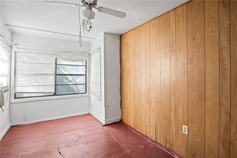 228 Southwest 8th Street Premont, TX 78375 - Photo 12 of 19 an empty room with windows and chandelier fan