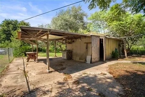 a backyard of a house with table and chairs