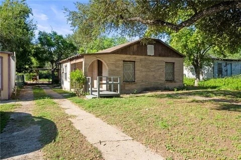 228 Southwest 8th Street Premont, TX 78375 - Photo 2 of 19 a front view of a house with garden