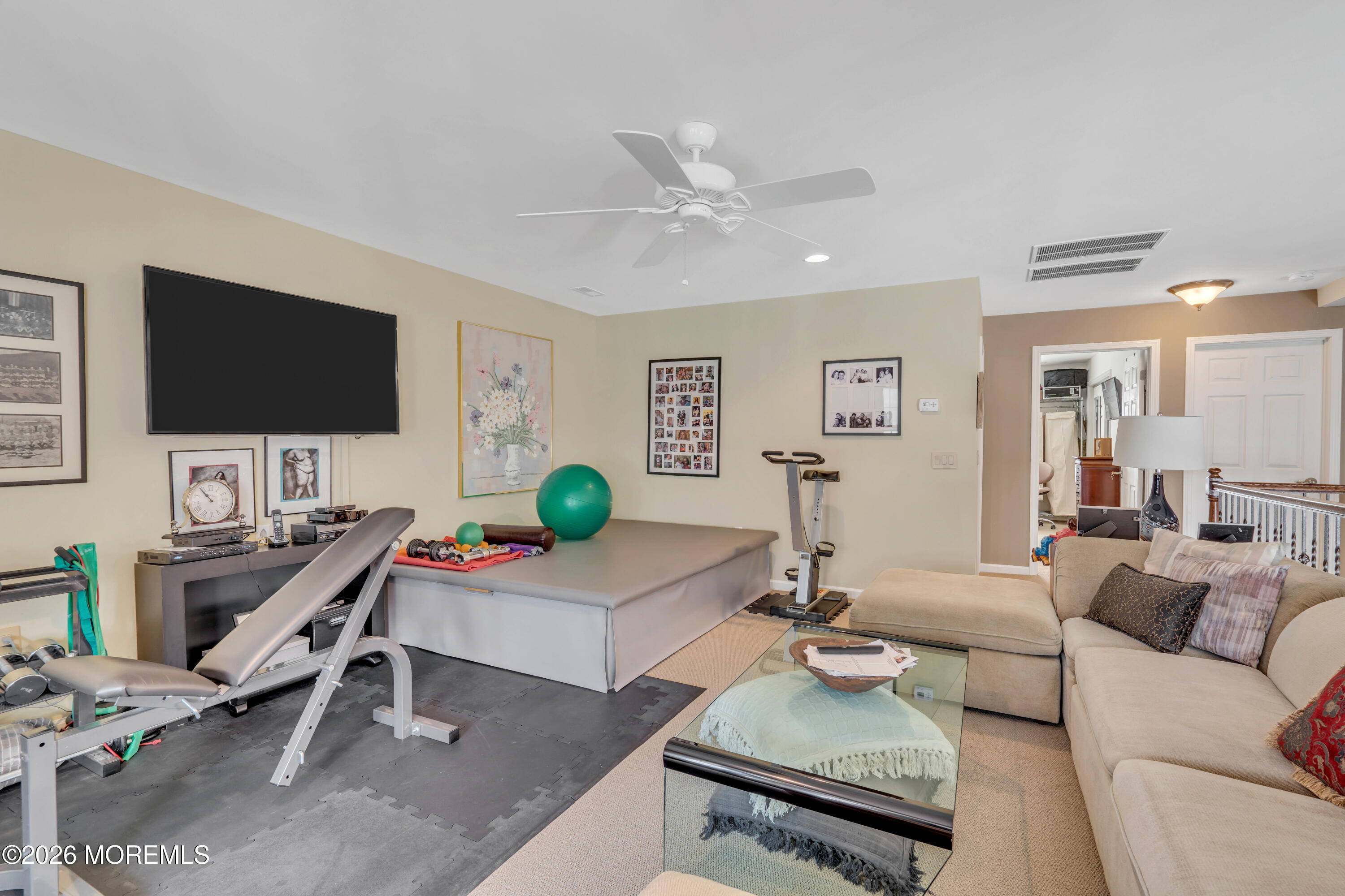 15 Enclave Boulevard Lakewood, NJ 08701 - Photo 48 of 81 a living room with furniture and a flat screen tv